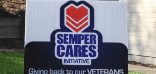 Semper Cares sign and balloons
